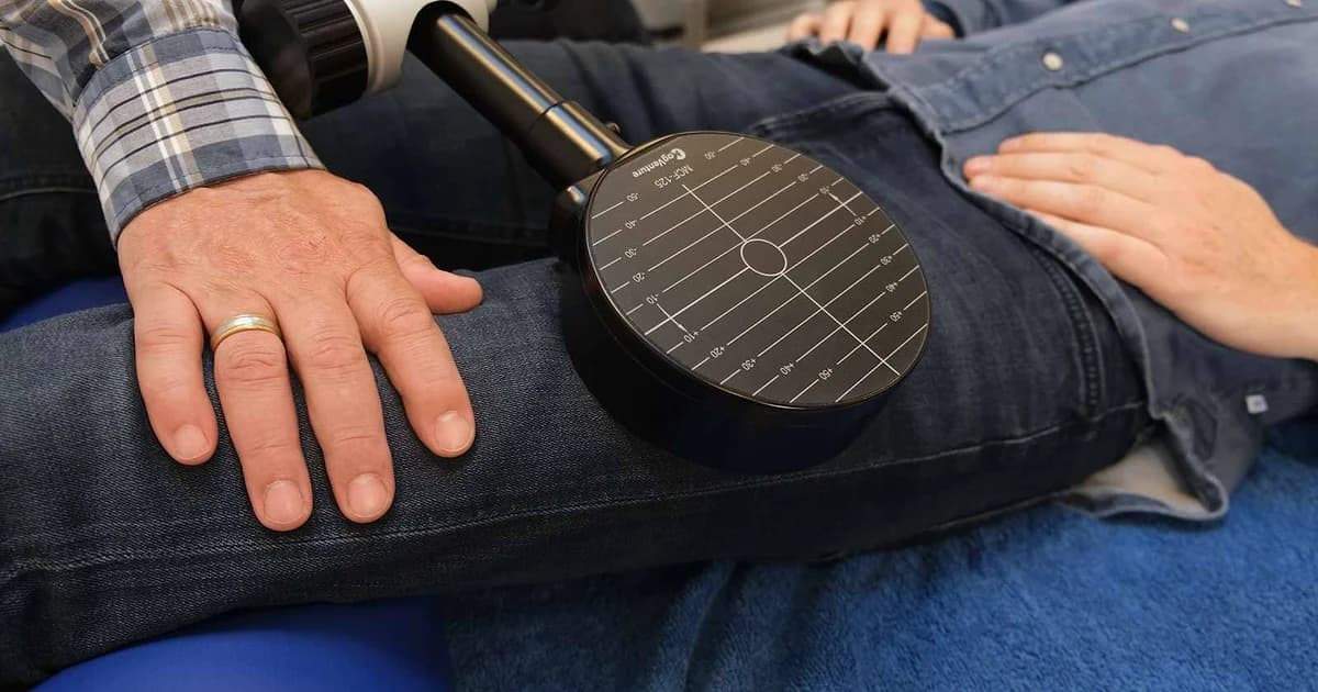 Official MagVenture Pain Therapy session photo showing a magnetic stimulation coil positioned for body pain care
